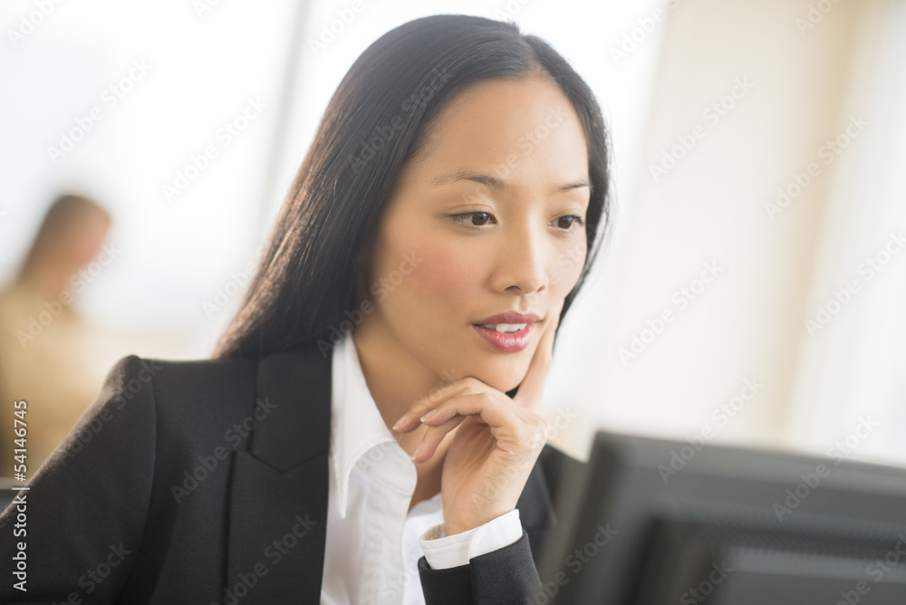 Mid Adult Businesswoman Working On Computer In Office Mid Adult Businesswoman Working On Computer In Office