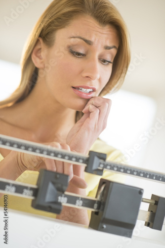 Worried Woman Using Balance Weight Scale