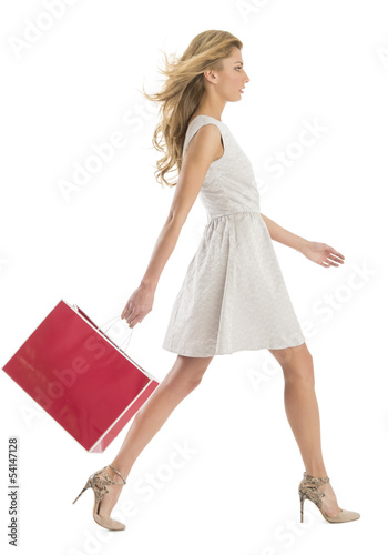 Side View Of Woman Walking With Shopping Bag