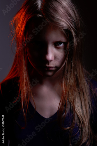 Closeup portrait of a scary little demon girl