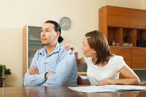  woman asking for money from  husband for the purchase photo