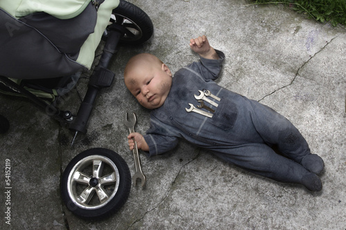 baby lying on the ground and repairing your stroller