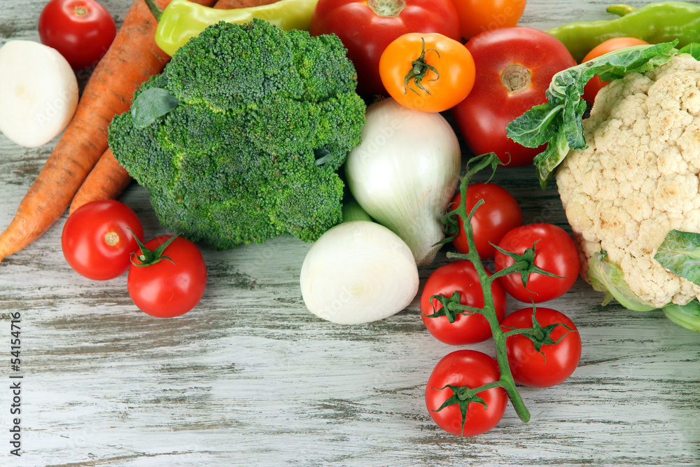 Fresh vegetables in basket on wooden table close-up Fresh vegetables in basket on wooden table close-up