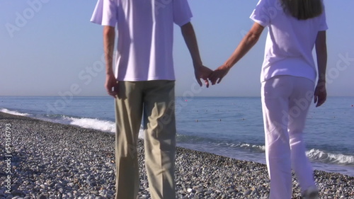 Young woman and the man go on seaside