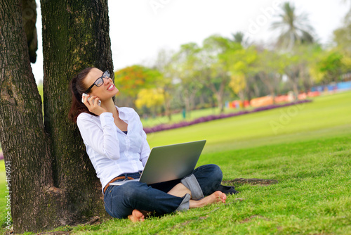 woman with laptop in park