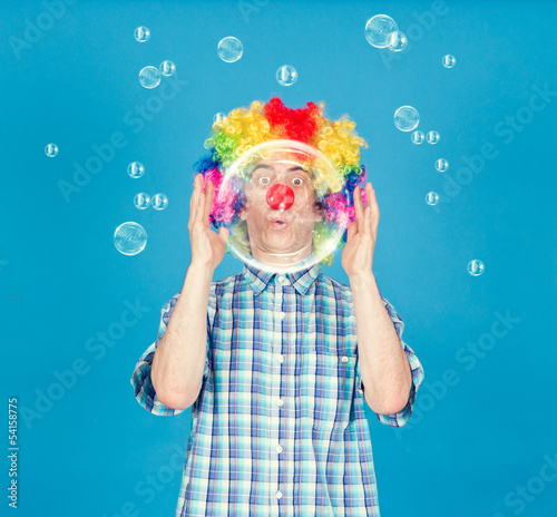 Funny clown with soap bubbles.