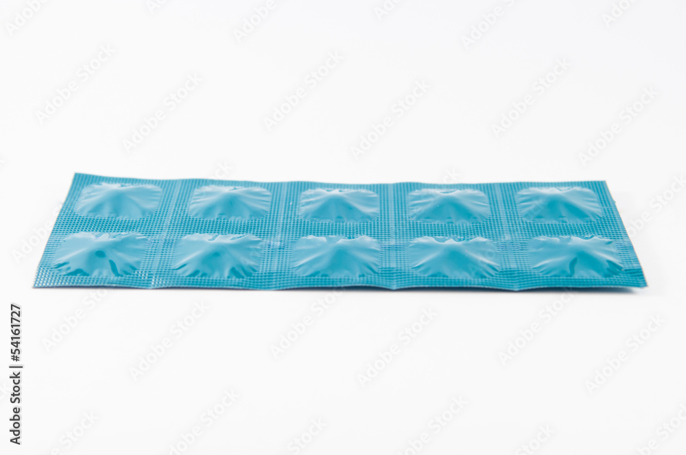 Closed up tablet in blue aluminum foil strip show medicine backg Closed up tablet in blue aluminum foil strip show medicine backg