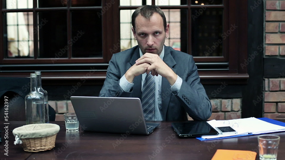 Serious businessman looking into camera Serious businessman looking into camera