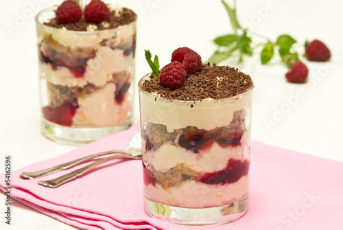 Yoghurt (creme fraiche) dessert with raspberries, decorated with