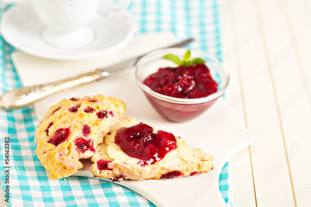 Scone with orange zest and berries with butter and jam Scone with orange zest and berries with butter and jam