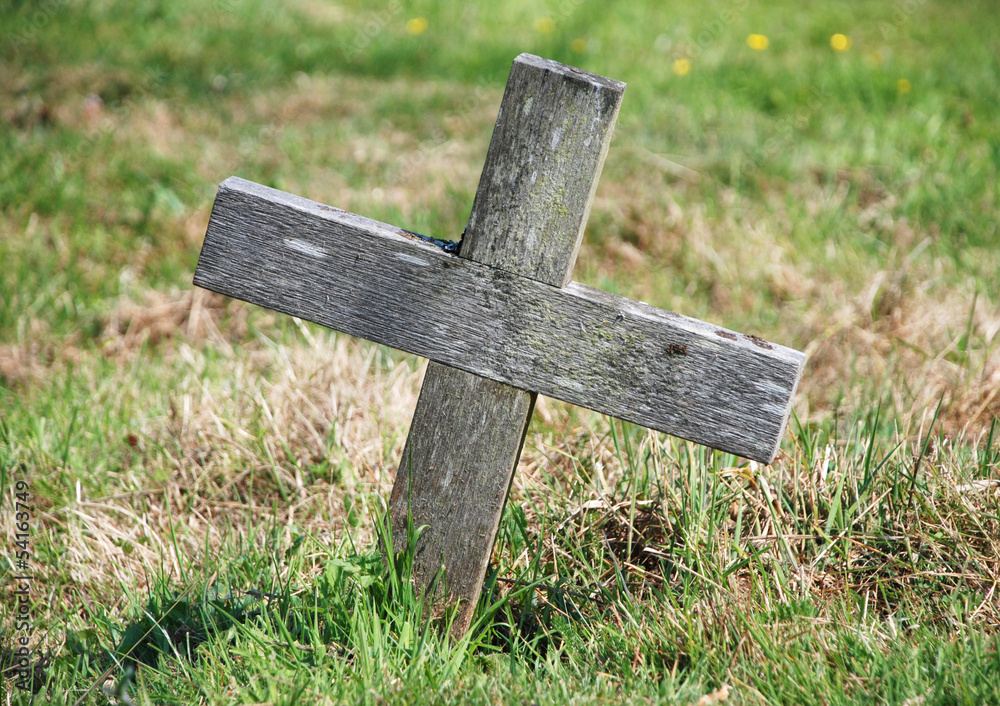 Wooden cross marking a grave Wooden cross marking a grave