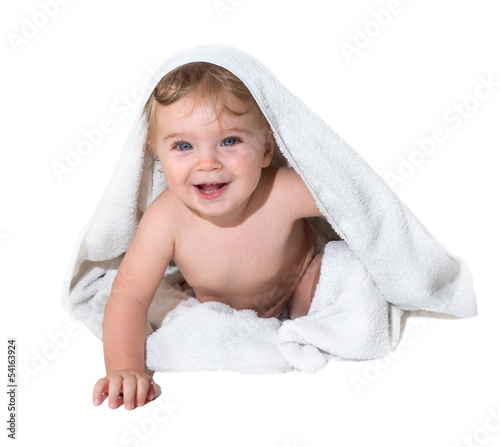 Beautiful little girl smiling under the towel
