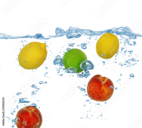 Fototapeta Naklejka Na Ścianę i Meble -  Tropical fruits falling into water with splash isolated on