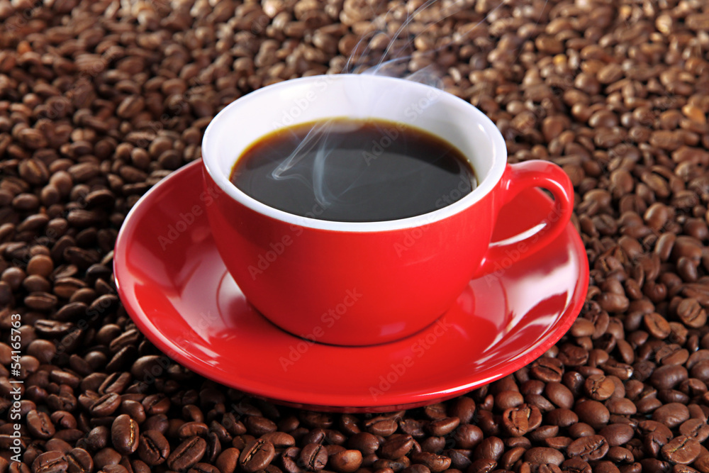 Cup of coffee on coffee beans background Cup of coffee on coffee beans background