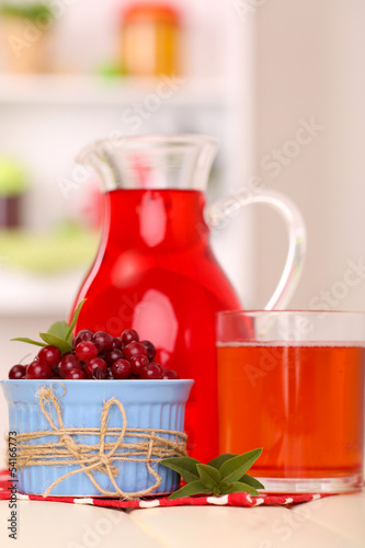 Pitcher and glass of cranberry juice with red cranberries © Africa Studio