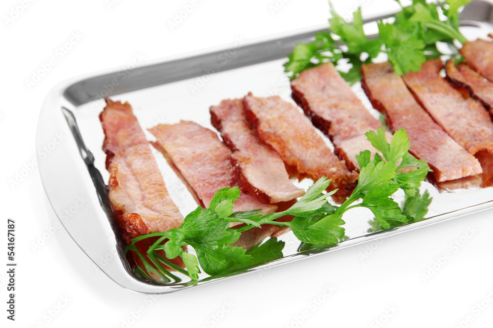 Fried bacon on metal tray isolated on white
