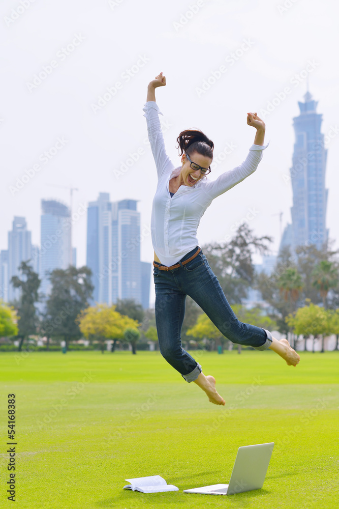 woman with laptop in park