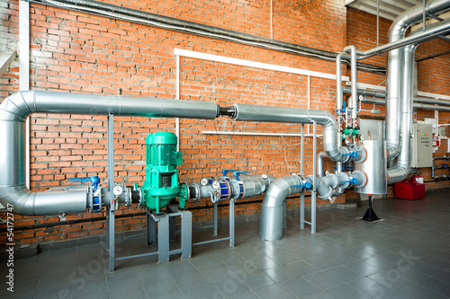 interior of an industrial boiler with pipes and pumps