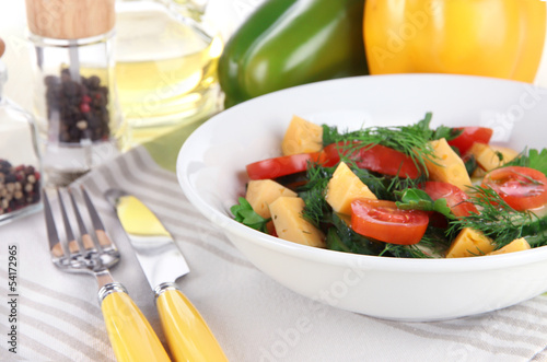 Light salad in plate on wooden table