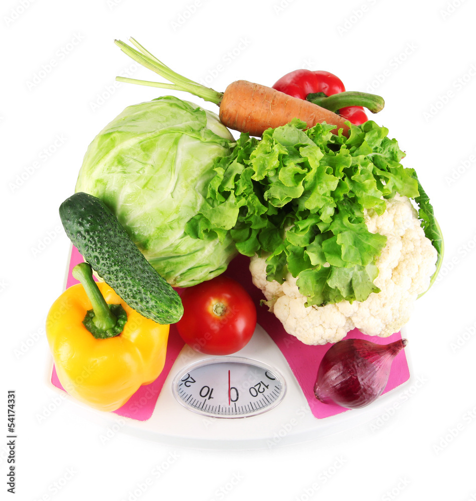 Fresh vegetables on scales on grey background Fresh vegetables on scales on grey background