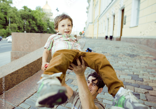 little son with father in city photo