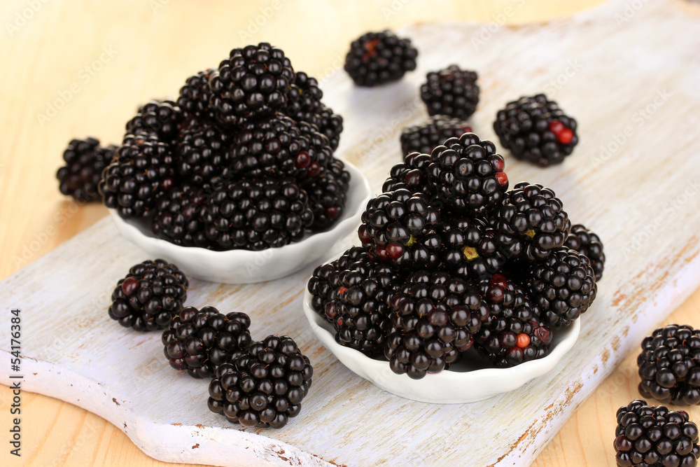 Sweet blackberry in bowls on wooden table Sweet blackberry in bowls on wooden table