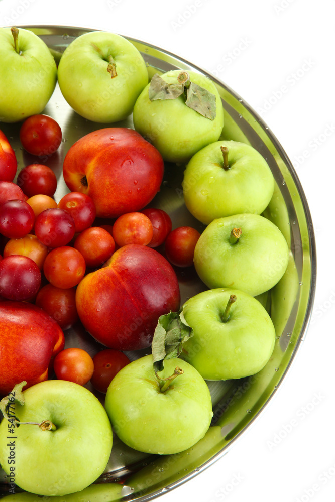 Assortment of juicy fruits on plate, isolated on white Assortment of juicy fruits on plate, isolated on white