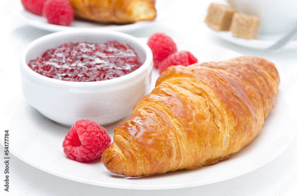 fresh croissant, raspberry and jam for breakfast close-up
