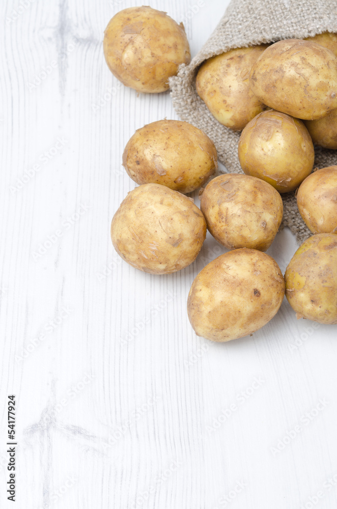 new potatoes in a sack on a white background with space for text new potatoes in a sack on a white background with space for text