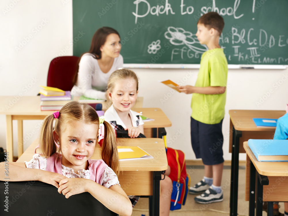 Children in classroom near blackboard. Children in classroom near blackboard.