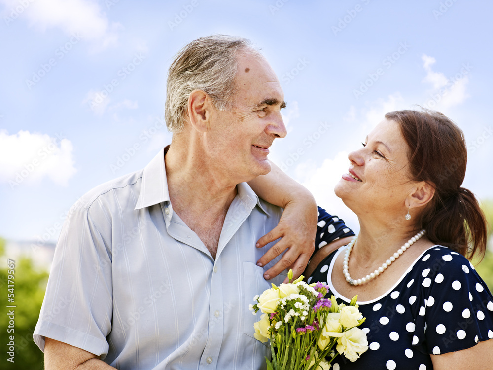 Portrait of old couple with bouquet at summer outdoor. Portrait of old couple with bouquet at summer outdoor.