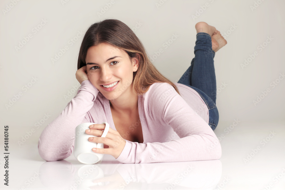 Smiling young brunette lying on floor Smiling young brunette lying on floor