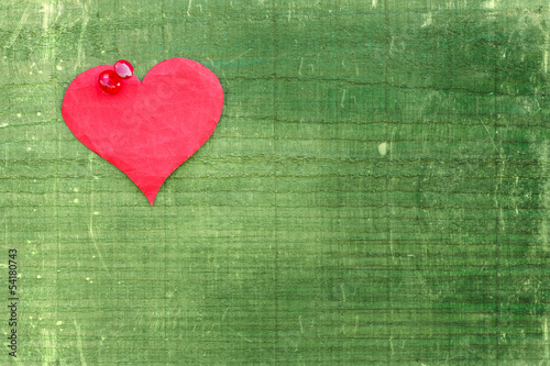 Heart pinned to the green  wall