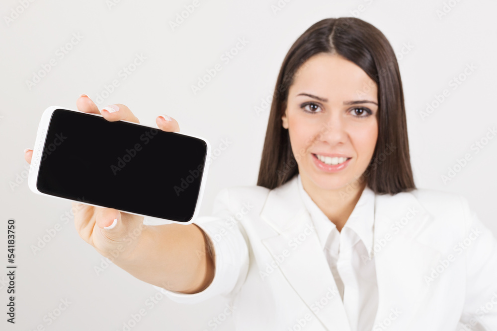 Happy businesswoman in white showing smartphone screen Happy businesswoman in white showing smartphone screen