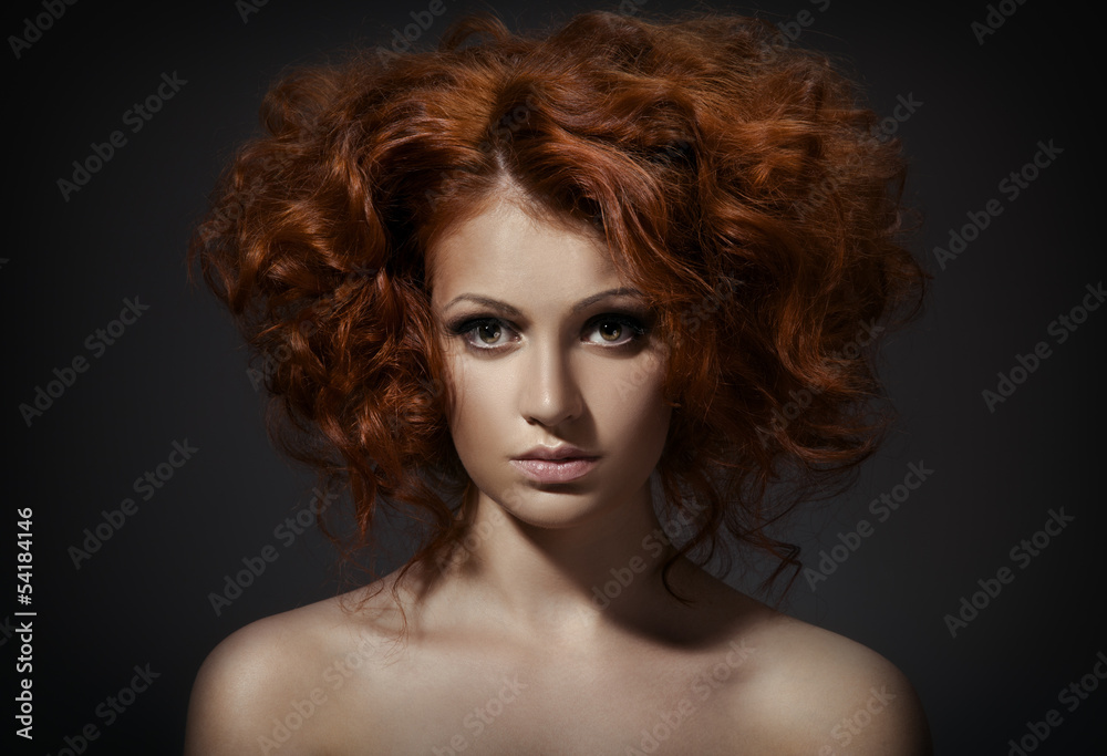 Beautiful woman with curly hairstyle against dark background Beautiful woman with curly hairstyle against dark background