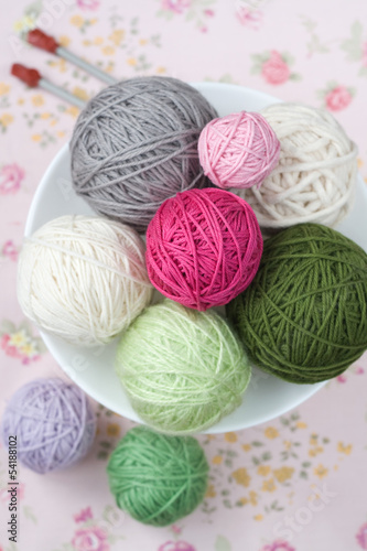 A lot of bright balls of knitting on the background