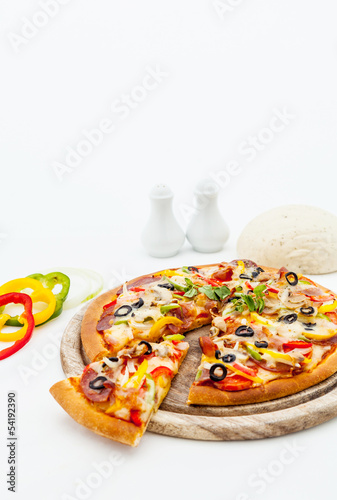Delicious homemade pizza with ham and vegetables.