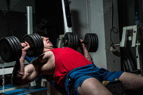 young bodybuilder doing bench press for chest