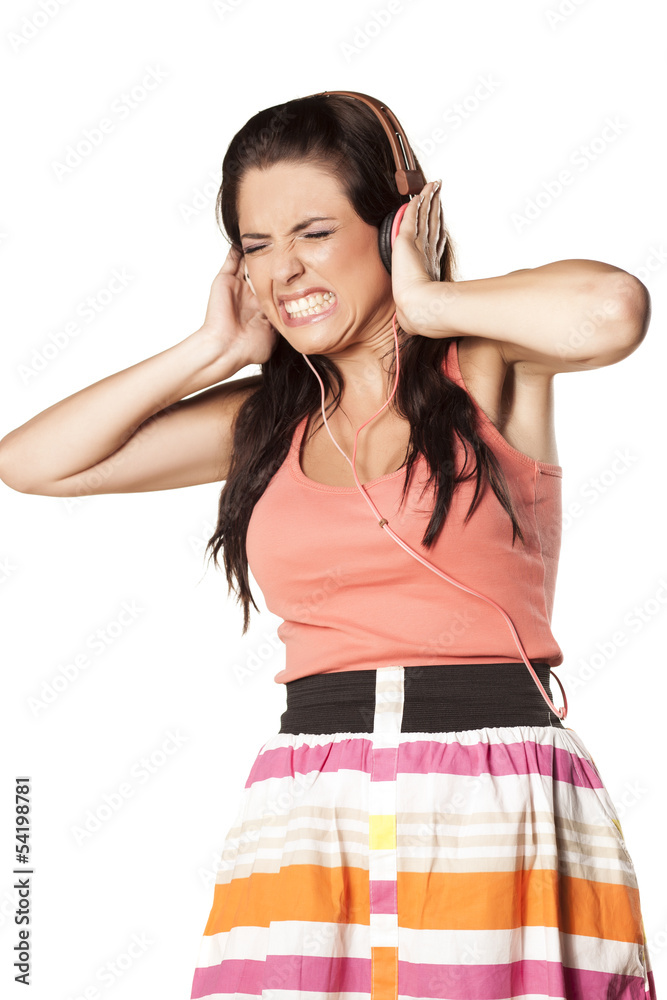 girl with painful grimace due to high volume of music girl with painful grimace due to high volume of music