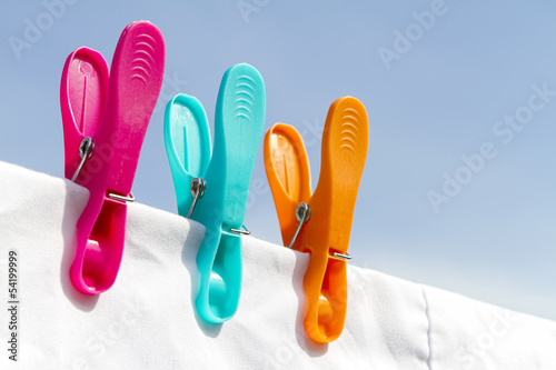 Three clothes pegs on a line