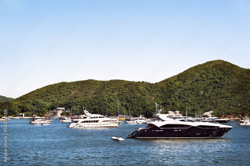 Luxury boats anchored in a bay off Hong Kong Island