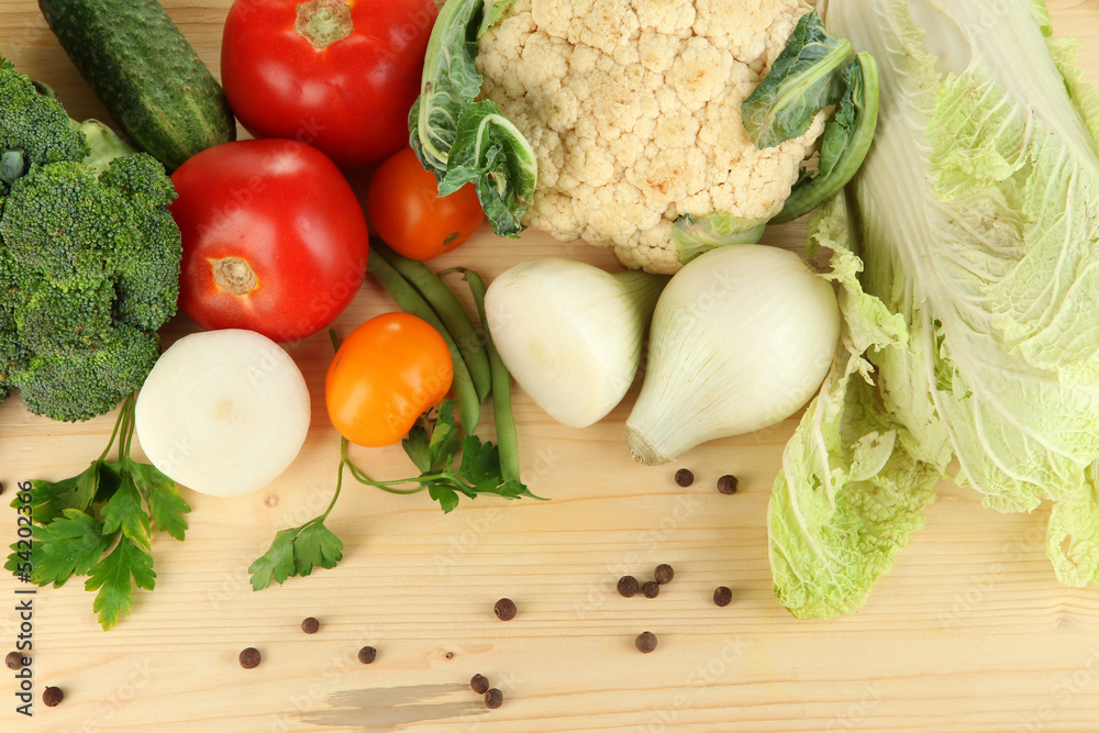 Fresh vegetables in basket on wooden table close-up Fresh vegetables in basket on wooden table close-up