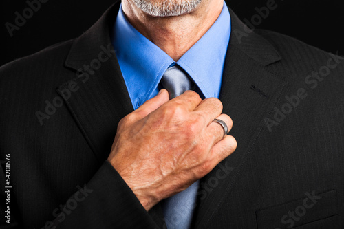 Businessman adjusting his tie