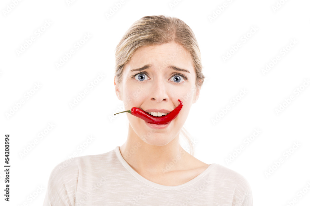 Woman with a silly face holding a red chilli pepper Woman with a silly face holding a red chilli pepper