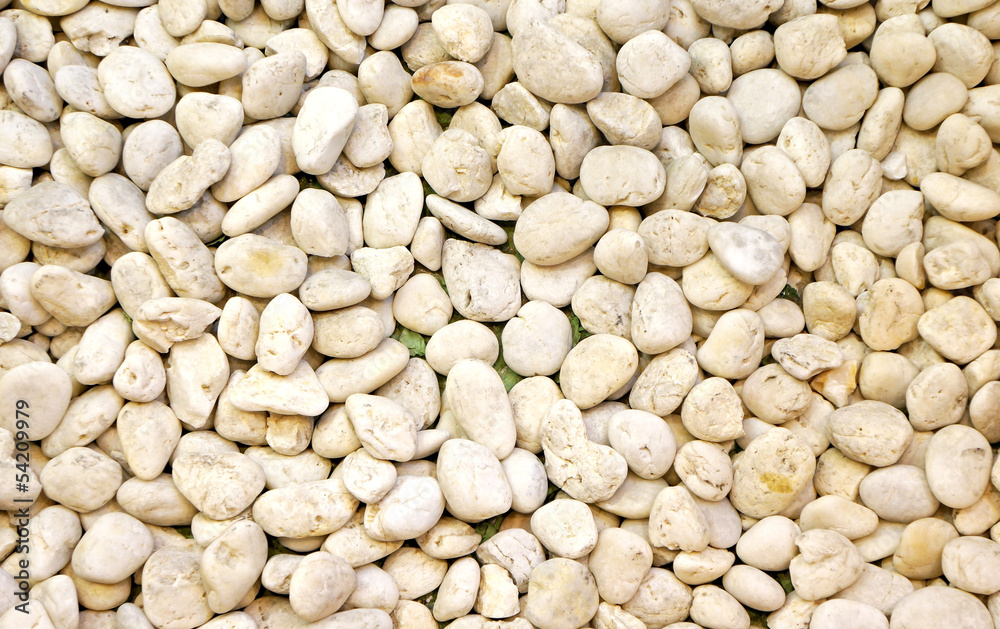 Small naturally polished white rock pebbles background Small naturally polished white rock pebbles background