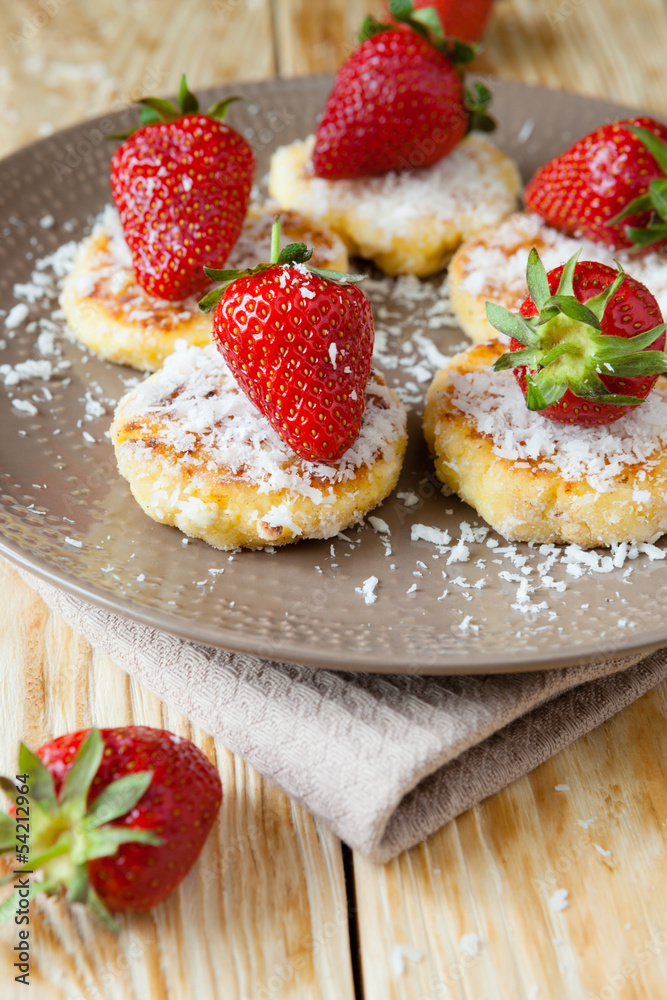 cheese pancakes with ripe strawberry and coconut
