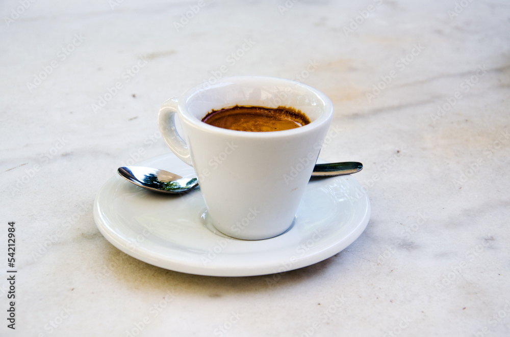 White espresso cup standing on the table of the street cafe White espresso cup standing on the table of the street cafe