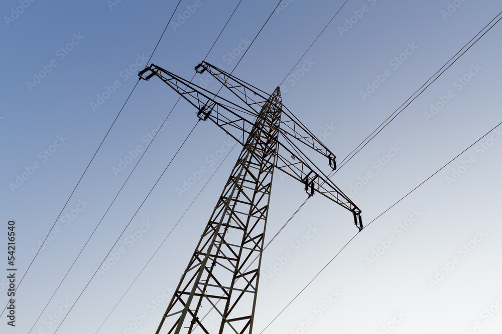 Electrical tower with power supply line against blue evening sky Electrical tower with power supply line against blue evening sky