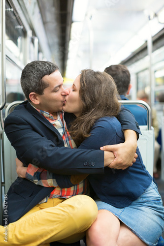 Couple kissing in the Parisian metro