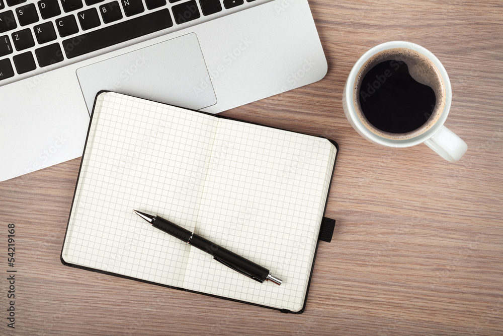 Notepad, laptop and coffee cup on wood table Notepad, laptop and coffee cup on wood table